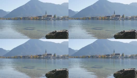 美丽的老教堂坐落在泰根湖岸边巴伐利亚阿尔卑斯山脉的背景下高清在线视频素材下载