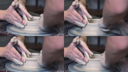 陶工师傅和他的学生用手在陶工转盘上磨平杯子的边缘高清在线视频素材下载