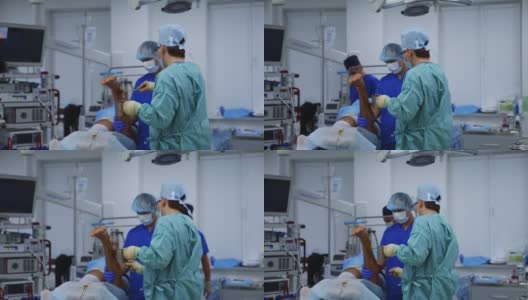 在手术室进行医疗程序医生在手术前准备好病人的腿。在现代诊所工作的医务人员。高清在线视频素材下载