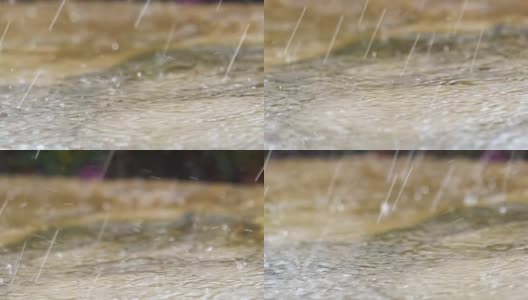 雨滴落在街道表面的特写镜头高清在线视频素材下载