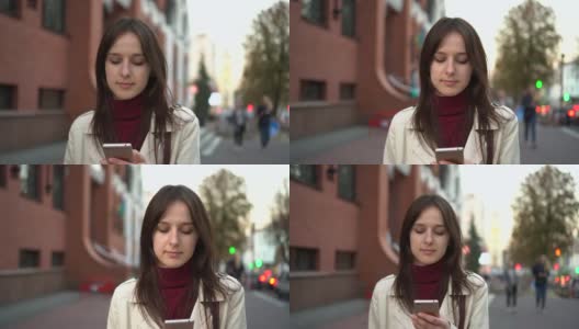 年轻女子拿着智能手机在城市里行走，用稳定器拍摄高清在线视频素材下载