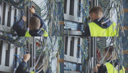 男性电工安装开关和连接电线到一个新的电气外壳高清在线视频素材下载