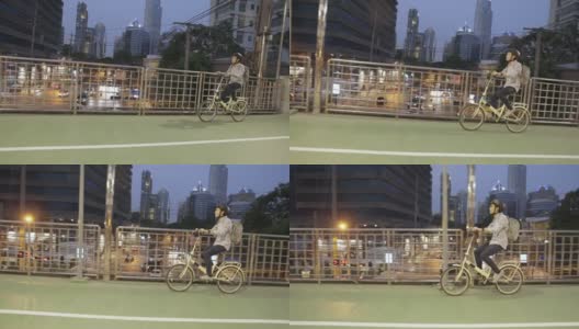 亚洲商人在立交桥上骑自行车高清在线视频素材下载