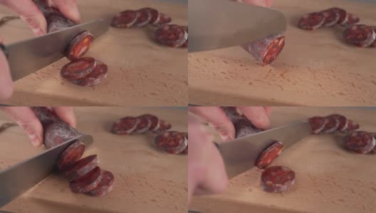 将西班牙传统自制香肠切成小块，放在木板上高清在线视频素材下载