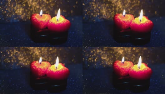 这是一个情人节，在闪亮的背景上插着燃烧的蜡烛高清在线视频素材下载