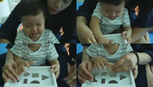 亚洲婴儿扮演医生和病人与母亲高清在线视频素材下载