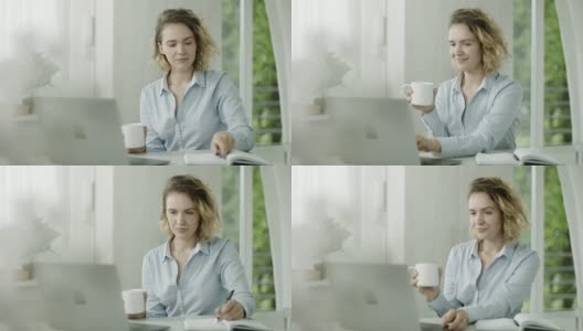 年轻女子用笔记本电脑工作，在办公室喝咖啡高清在线视频素材下载