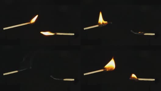 两根燃烧和消退的火柴，水平地，以一个角度，孤立在一个黑色的背景上。可以在你的视频中使用一次一个剪。高清在线视频素材下载