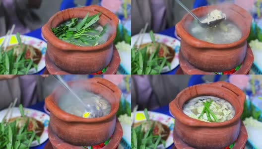 女孩将蔬菜填入砂锅，制作泰式火锅街头小吃(Jim Jum)高清在线视频素材下载