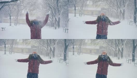 年轻女子在户外享受冬日。雪的冬天的梦想。慢动作高清在线视频素材下载