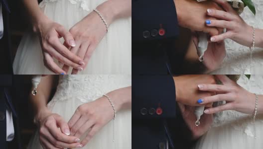 新娘把双手放在膝盖上。左手戴着漂亮的珍珠手镯高清在线视频素材下载