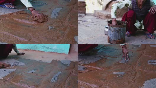 印度妇女用牛粪打扫屋子。高清在线视频素材下载