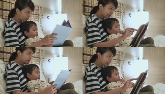 妈妈在家里给儿子读书。高清在线视频素材下载