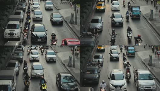从上面俯瞰曼谷的交通，日落，汽车和公共汽车沿着道路行驶，自行车在其间穿梭。高清在线视频素材下载