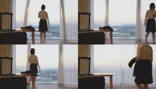 亚洲女商人走进酒店房间，拉上窗帘看风景高清在线视频素材下载