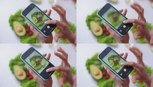 用手机的相机拍蔬菜沙拉的女人的特写。高清在线视频素材下载