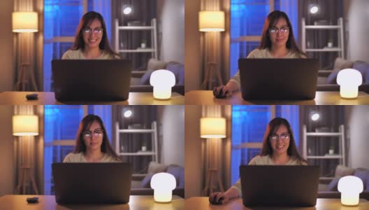 亚洲女性在晚上使用笔记本电脑高清在线视频素材下载