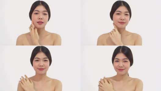 美丽和性感的亚洲女人的肖像在白色的背景。美丽的女人触摸她的脸，对着镜头微笑高清在线视频素材下载