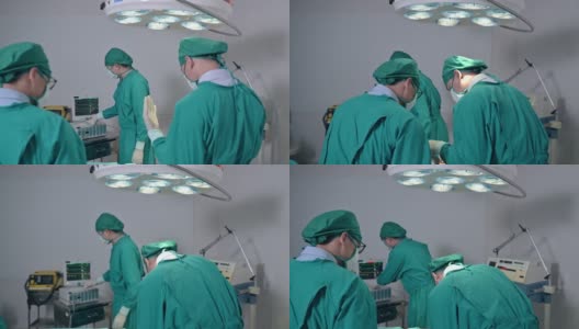 在医院的手术室里，外科医生们穿着手术服给一名严重受伤的病人做手术高清在线视频素材下载