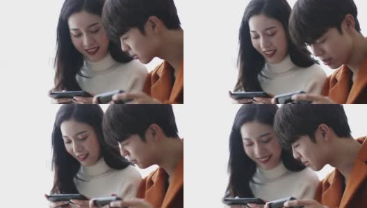 年轻的亚洲夫妇在玩手机高清在线视频素材下载