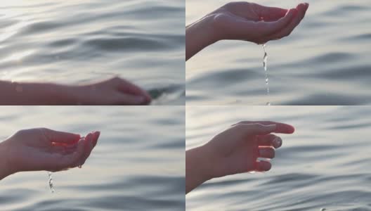 一个女人的手的特写是轻轻触摸海面上的海浪在日落高清在线视频素材下载