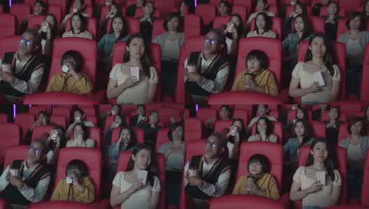 亚洲华人活跃的老人和孙女喜欢在电影院看恐怖电影高清在线视频素材下载