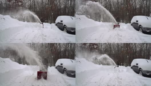 在一场冬天的暴风雪后，一名男子正在清理他被雪覆盖的汽车周围的车道。高清在线视频素材下载