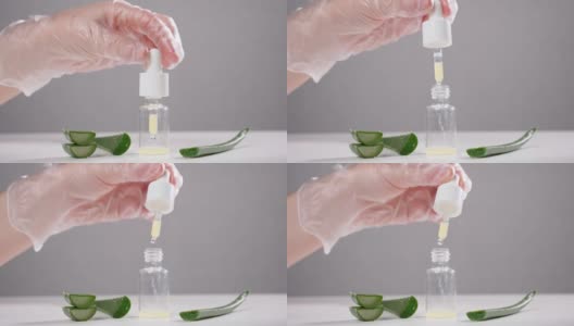 专家将芦荟汁滴入白色桌上的玻璃瓶中高清在线视频素材下载