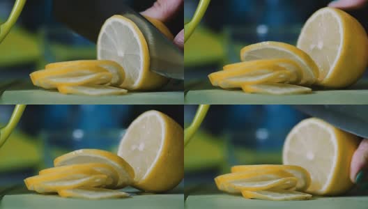 从一个躺在桌子上的柠檬上切下一把刀。高清在线视频素材下载