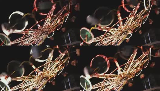 游乐园芭蕾舞者骑在五颜六色的灯光在晚上拍摄-有趣的活动视频背景高清在线视频素材下载