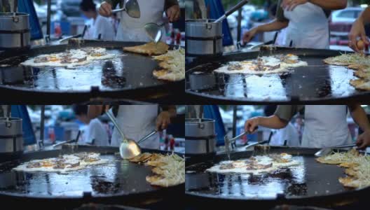 蚝油煎:一种由面粉和水混合而成的泰国食物。在热油中炸。煎贻贝煎饼，蛋糊煎贻贝，再放贻贝或牡蛎炒蛋，街头小吃。4k。高清在线视频素材下载