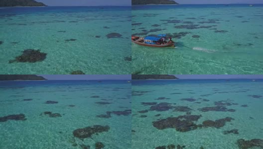鸟瞰图的热带海滩，长尾船和岩石海岸与清澈的绿松石水在泰国岛，日出海滩，Koh Lipe，萨顿，泰国高清在线视频素材下载