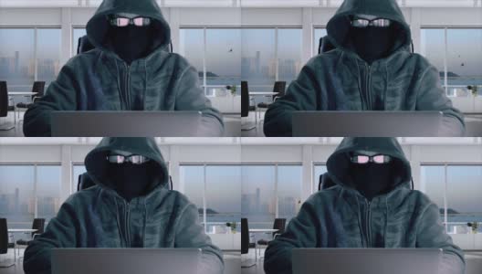 匿名程序员在掩码编码和打字在笔记本电脑在办公室。戴着眼镜戴着巴拉克拉瓦帽的黑客正在输入程序代码。高清在线视频素材下载