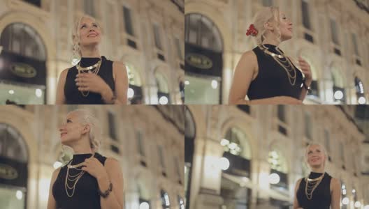 快乐的女人在世界上最古老的购物中心之一，晚上在米兰高清在线视频素材下载