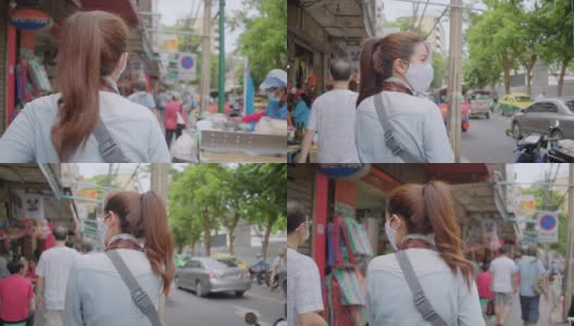 亚洲成年妇女在当地旅游的地方散步和购物。有吸引力的女性寻找街头食品，而旅行在当地地区。独行侠的概念。高清在线视频素材下载
