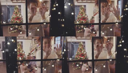 快乐的女孩一边在窗前装饰雪花，一边先下大雪，构思冬天和圣诞节的场景高清在线视频素材下载