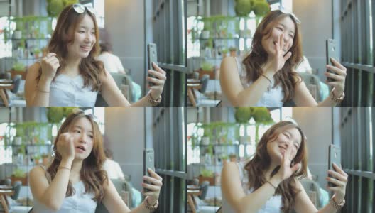 一名在咖啡店使用智能手机的亚洲女性高清在线视频素材下载