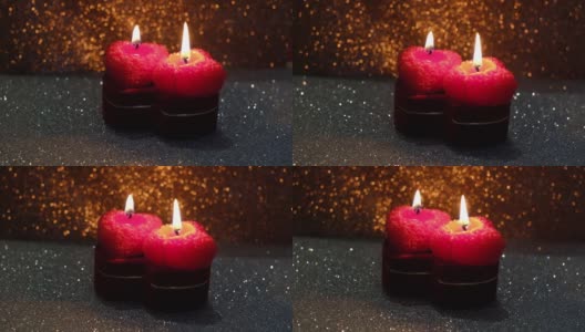 这是一个情人节，在闪亮的背景上插着燃烧的蜡烛高清在线视频素材下载