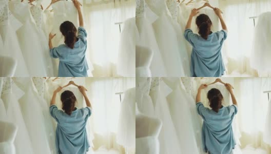 新娘商店的老板是工作和制作婚纱在她的零售与工艺品的小生意高清在线视频素材下载