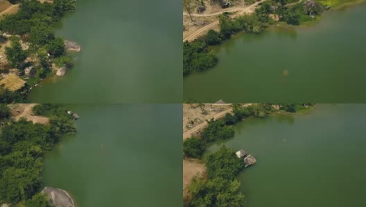 绿色的水和岸上的大石头美丽的湖空中拍摄无人机。公路沿河与岩石海岸无人机视图高清在线视频素材下载