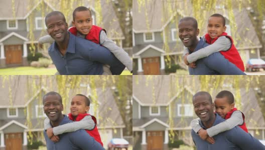 非裔美国人父亲和儿子在户外院子里的肖像高清在线视频素材下载