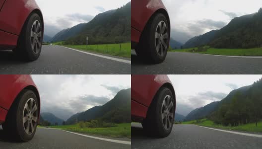 Close up front car wheel on the asphalt alpine road高清在线视频素材下载