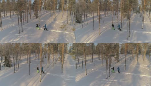 天线:活跃的夫妇在温暖的冬天穿着雪鞋在厚厚的雪地上徒步旅行高清在线视频素材下载