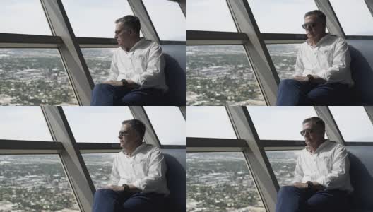 一个男人从高层酒店的窗户向外看高清在线视频素材下载