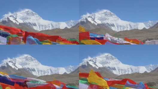 近距离:彩旗在远处被风吹拂的珠穆朗玛峰前飘扬高清在线视频素材下载