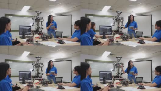 亚洲女性工程师目前机器人创新与建筑师设计团队在实验室。团队会议分享技术理念和协作开发机器人。表示机器人技术的概念。高清在线视频素材下载