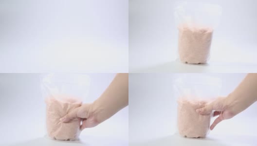 粉红色的盐在透明的塑料袋孤立在白色的背景。包装模板模型收集。高清在线视频素材下载