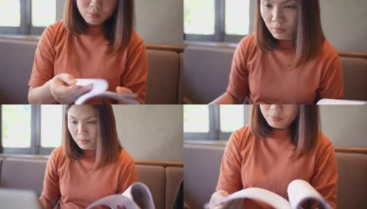 亚洲女性工作与笔记本电脑和阅读文件分析高清在线视频素材下载