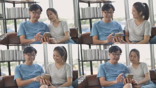 亚洲老年夫妇在家里用智能手机打视频电话高清在线视频素材下载