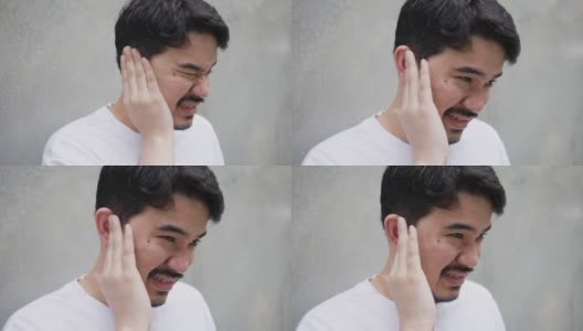 慢镜头:成年中东男子在感觉耳膜疼痛后用手按摩耳朵，这是一种不健康的生活方式高清在线视频素材下载